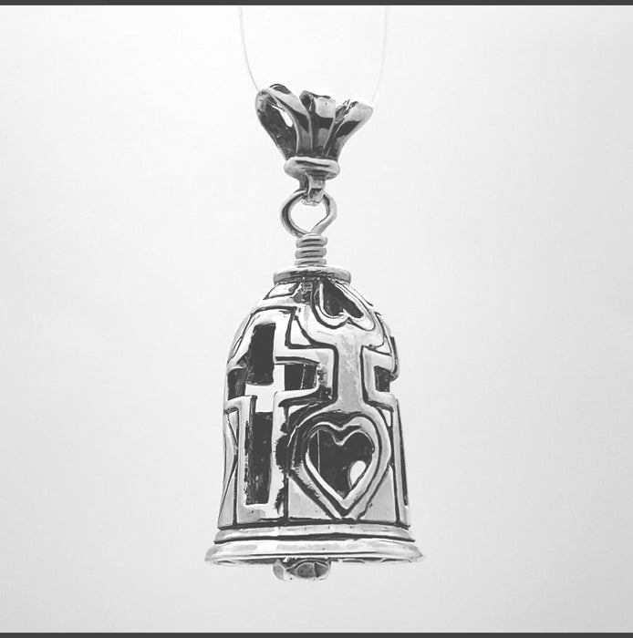 In this video you can see our handcrafted sterling silver pendant, the Bell of Christ. It has three crosses around the body of the bell, hearts are prominent to remind us of His eternal love and the clapper is in the shape of a nail.