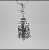 In this video you can see our handcrafted sterling silver Four Seasons Bell Pendant. The Four Seasons Bell Pendant features a spring flower, summer sun, autumn leaf and winter snowflake, it also has a crescent moon bail and the pendulum of a grandfather clock for a clapper.