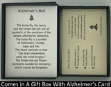 The Alzheimers Charm Bell will be carefully packed in a black gift box, with the gift card in the lid. A silver elastic bow closes the box.