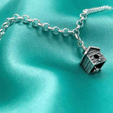 The Birdhouse Charm Bell is a beautifully detailed and unique sterling silver bell charm. The clapper is a hummingbird taking flight, gently ringing the bell as it moves.