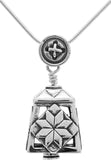 Handcrafted in Sterling Silver, the Peace by Piece Bell Pendant features two different quilt patch blocks on its sides, the bail is a button, and the clapper is a thimble.