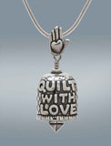 Handcrafted in Sterling Silver, the sterling silver Quilt With Love Bell Pendant features the words "Quilt With Love" on one side and a sewing machine on the other, the bail is a hand with a heart, and the clapper is a quilt patch.