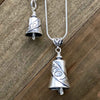 Handcrafted in Sterling Silver, the Treasured Mom Pendant and charm have a ribbon wrapped around it that says "MOM". On each side is a delicate heart cut out, giving it an open, airy style. The pendant is larger and adds a bail at the top for a necklace.