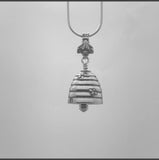 In this video you can see our handcrafted sterling silver Bee Bell pendant, its shaped like a bee hive with bees flying around the hive. The clapper is a honey dipper and the bail is bee.
