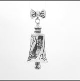 In this video you can see our handcrafted sterling silver Granddaughter Bell Pendant. Handcrafted in Sterling Silver, the Granddaughter Bell Pendant has a bow for a bail. Graceful spiraling cutouts frame the word "Granddaughter" along its sides with tiny clumps of flowers.
