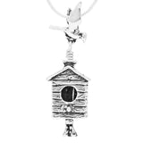 Handcrafted in Sterling Silver, the bail is a bird taking flight over the birdhouse while a flower blossom clapper gently rings this bell.