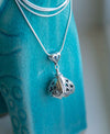 Handcrafted in Sterling Silver and shaped like a Hershey's Kiss, its sides are adorned with delicately cut out hearts and the clapper is shaped like cupid’s arrow.  The You Are Loved Bell Necklace Gift Set will come with a snake chain, polishing cloth, and a gift box with a card.