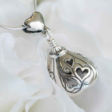 "I Love You Now, I'll Love You Forever." Handcrafted in Sterling Silver and shaped like a Hershey's Kiss, the heart design of this sterling silver You Are Loved Bell Pendant is both beautiful and captivating with cut out hearts adorning its sides and cupid’s arrow as the clapper.
