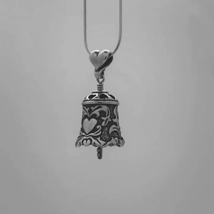 In this video you can see our handcrafted sterling silver Love Bell Pendant. Featuring prominent hearts accented with a graceful scroll work design, the key to your heart hangs from the bell's clapper.