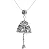 Handcrafted in sterling silver, the pendant's bell body looks like palm tree fronds. The palm tree's distinctive trunk hangs below, forming the bell's clapper and the pendant's bail is a crescent moon hanging above the palm tree.